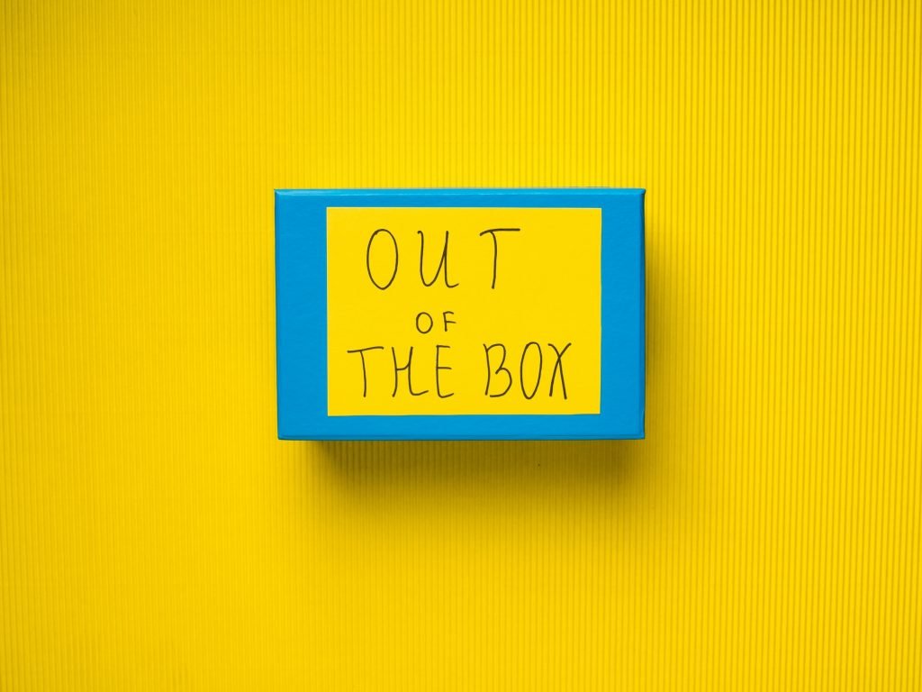 Blue box on yellow background. Out of box concept