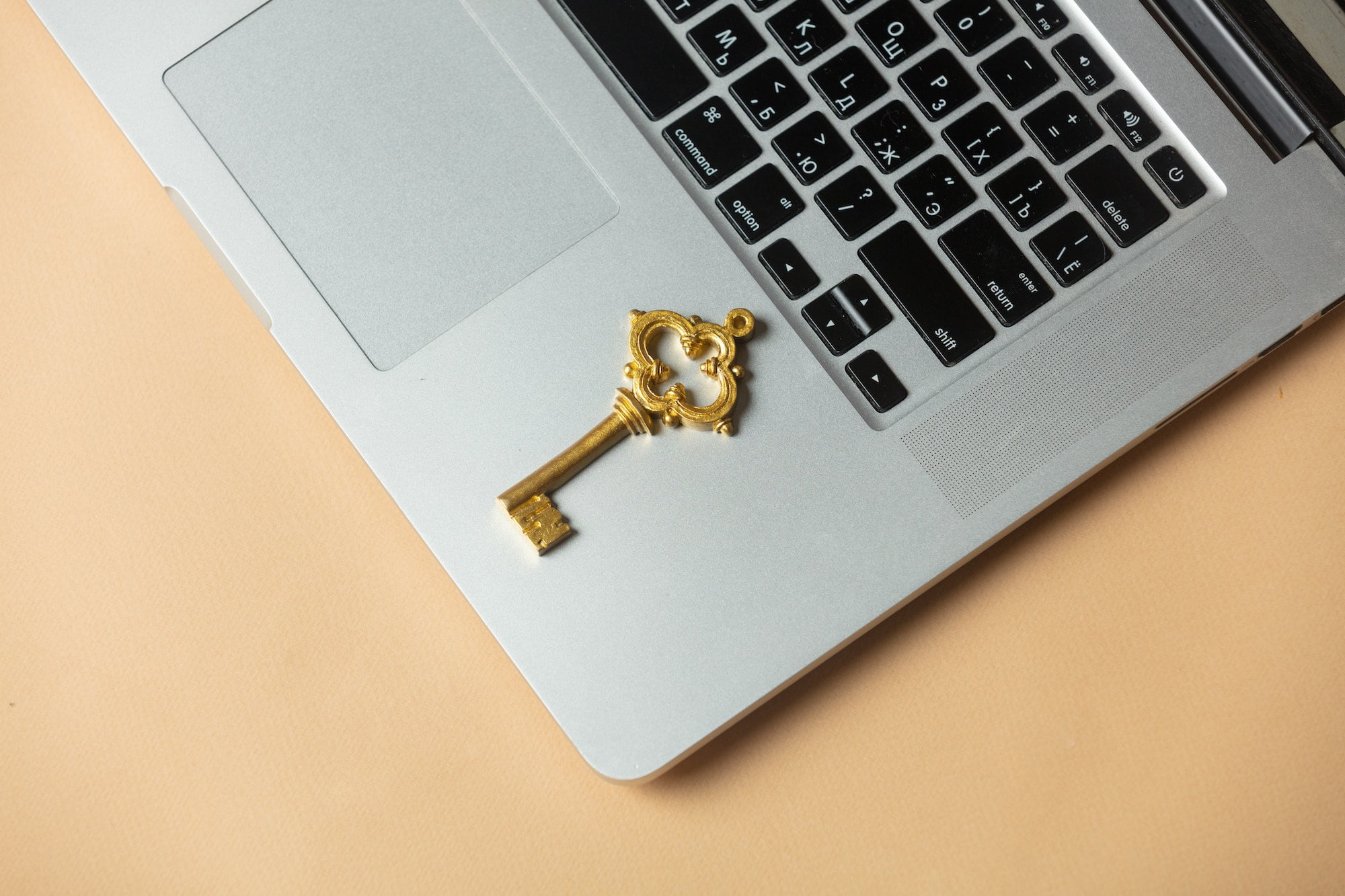 Golden key on laptop computer, above view